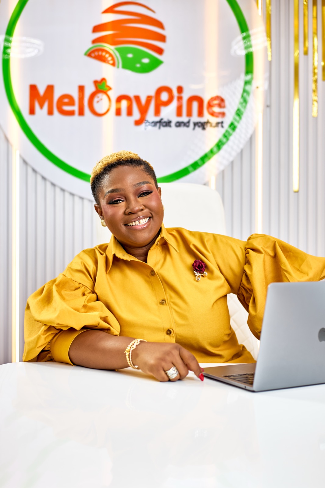 Augusta Nkanu seated at a desk with a laptop at MelonyPine